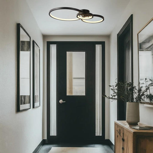 Black flush-mount ceiling light, by Maple, for hallway, bedroom, or entryway, angled view