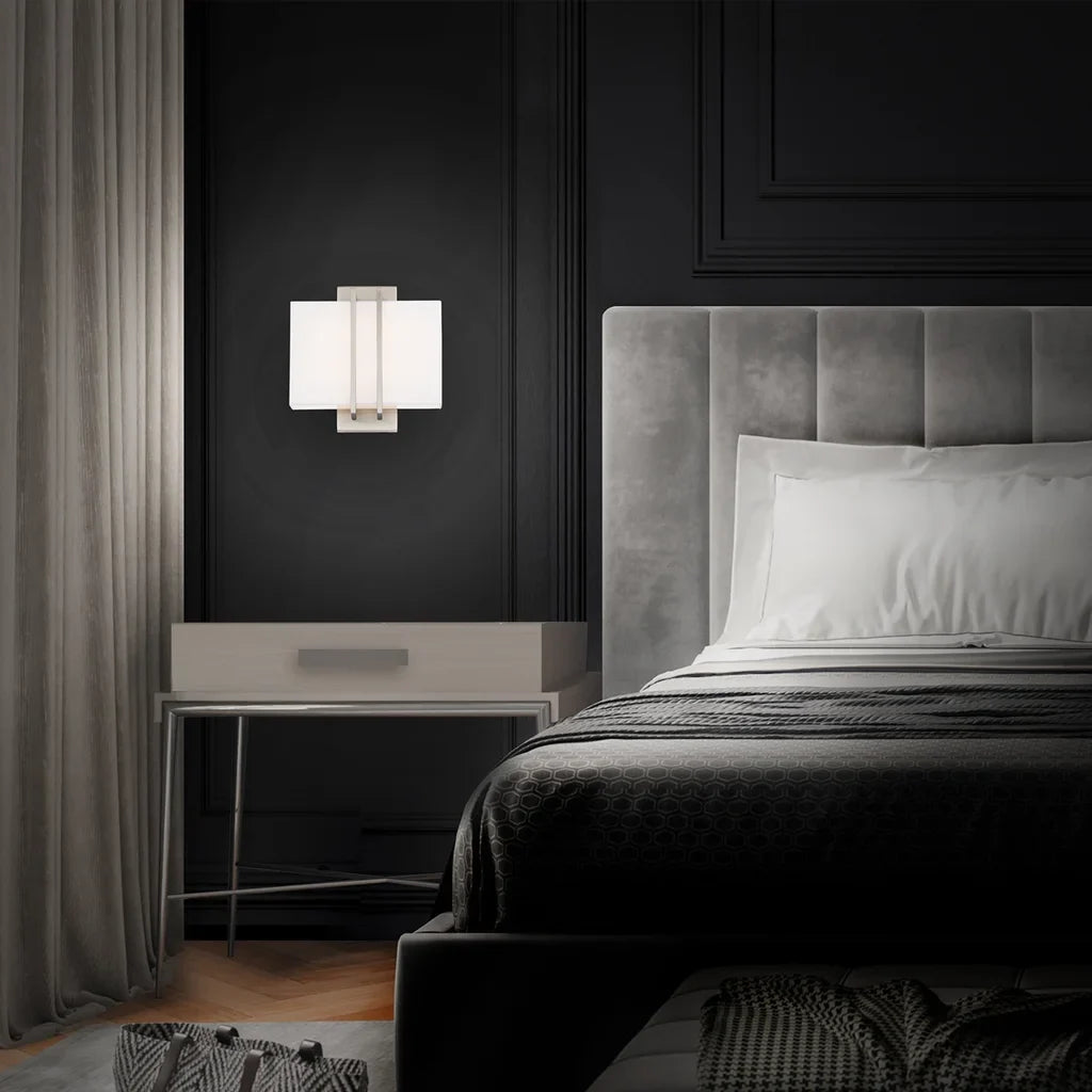 A cozy bedroom lighting collection featuring elegant bedside lamps with fabric shades and brushed nickel bases, designed to create a warm and inviting ambiance for relaxation and comfort.