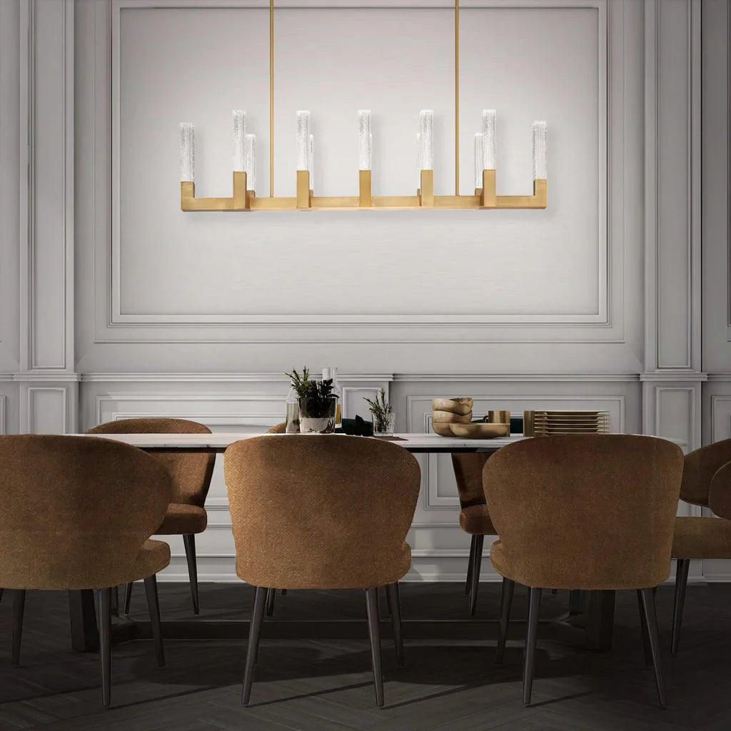 An elegant dining room lighting collection featuring a statement linear pendant with crystal accents and a brushed gold finish, designed to create a sophisticated focal point for dining spaces.