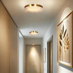 Gold flush-mount ceiling light, by Maple, for hallway, bedroom, or entryway, angled view