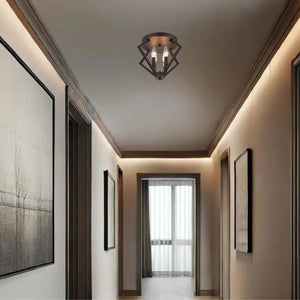 Iron with orb flush-mount ceiling light, by Maple, for hallway, bedroom, or entryway, angled view